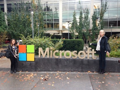 employees in front of microsoft sign